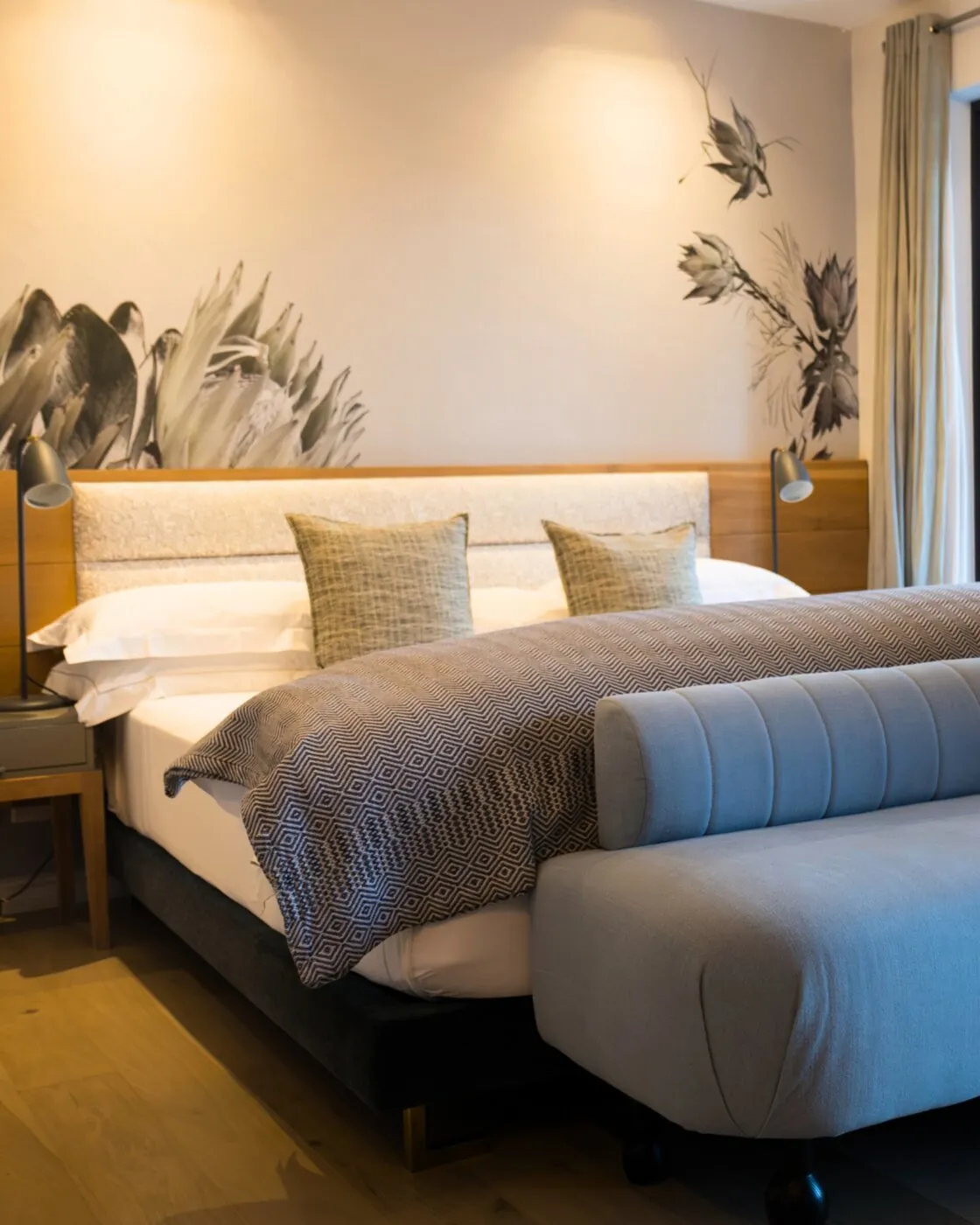 Standard Room at Kensington Place with king bed and botanical artwork