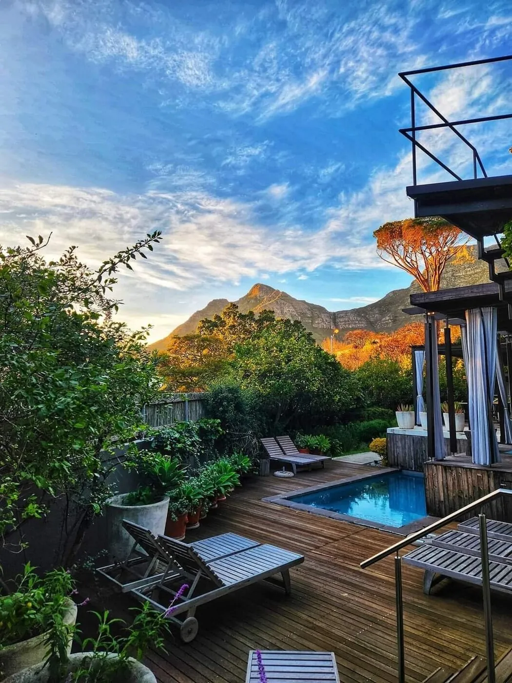 Sunlit pool deck at Kensington Place with Table Mountain behind