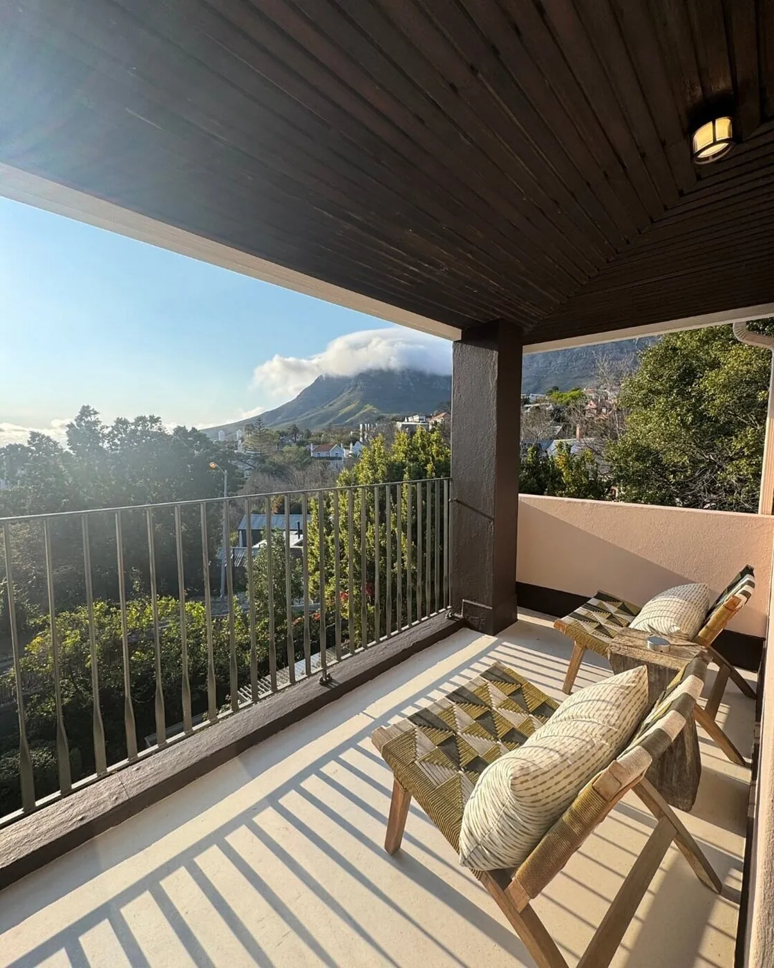 Private balcony with loungers overlooking the city and mountains